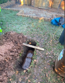 Soakaway trial hole being filled with water near Leicester
