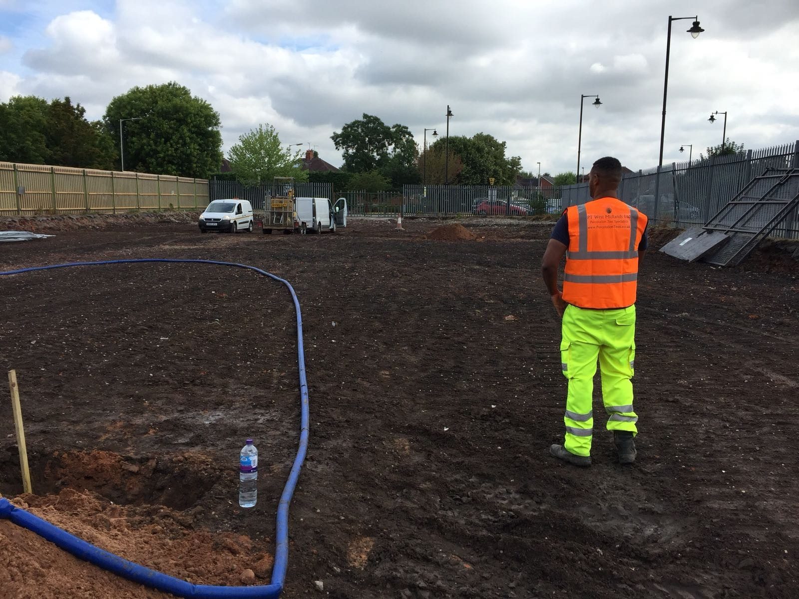 Soakaway trial hole being filled with water near Kenilworth
